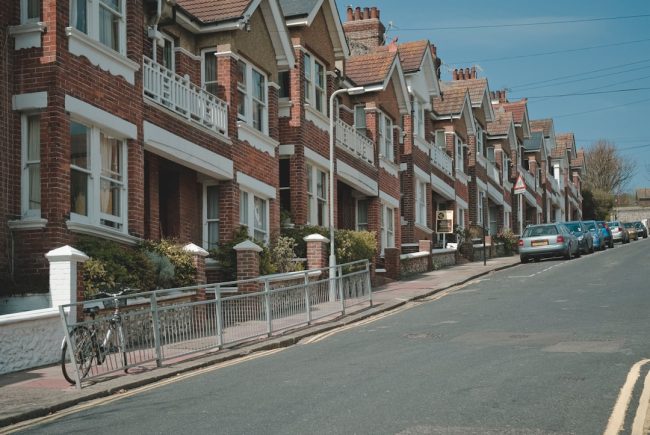 Row of UK homes, representing the impact of mortgage rate rises on borrowers