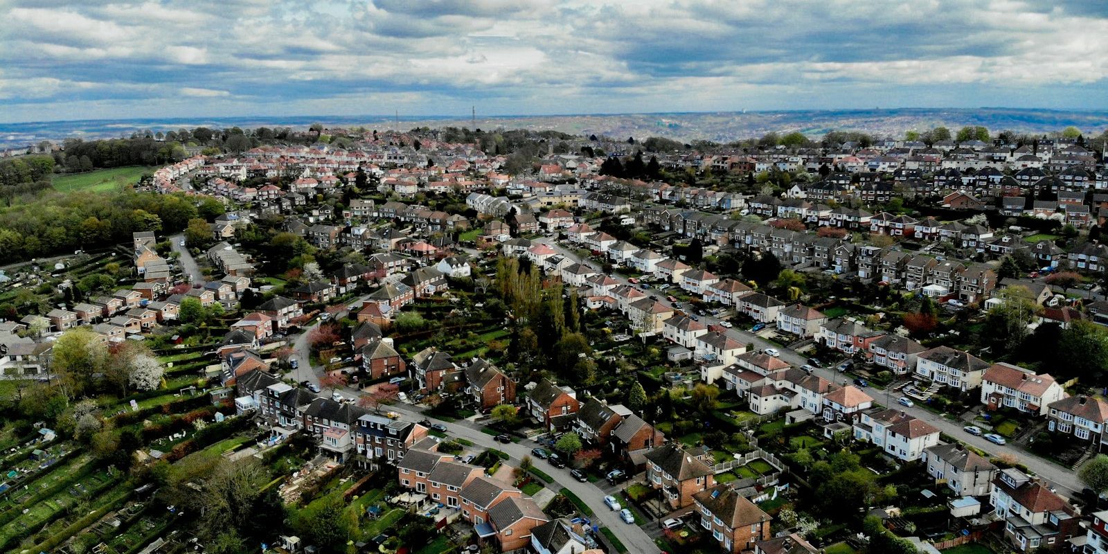 Share purchase vs asset purchase – property portfolio rooftops Aerial view of residential rooftops representing a buy-to-let property portfolio